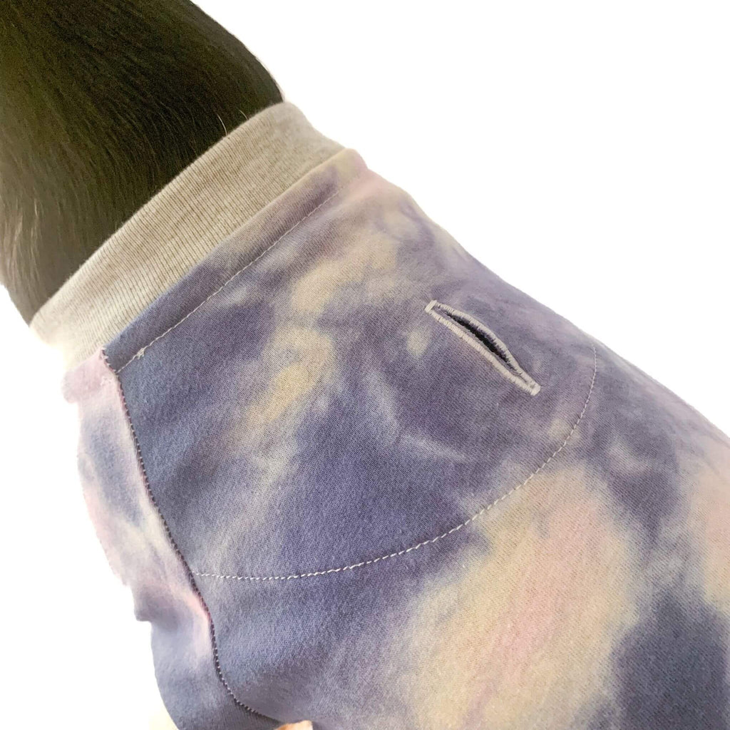 Photo shows closeup of the Hudson Houndstooth raglan dog tshirt in the pastel tie dye print. Shows closeup view of buttonhole at center back for harness attachment and super soft light grey rib trim at neckline designed for all day comfort both inside and outside.