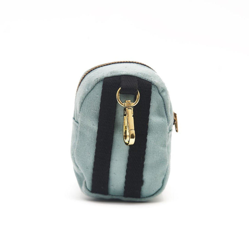 Back of the aqua dot jacquard dog backpack waste bag and treat dispenser shows two half inch black recycled polyester straps to help secure to leash, or attach to your dog's harness. It also includes a black tab with a gold brass swivel lobster clasp to clip to dog leash.
